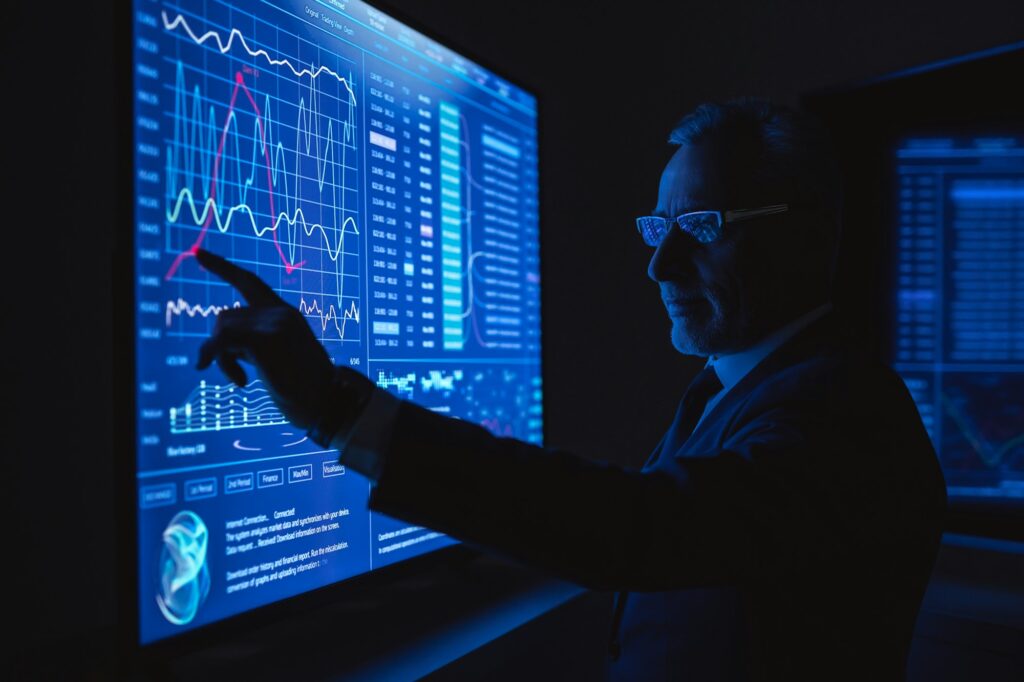 The businessman works on the big sensor display in the dark office